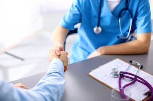 Addiction treatment doctor shaking hands with patient