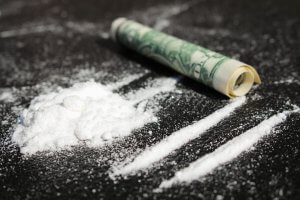 Cocaine lines on table with dollar bill