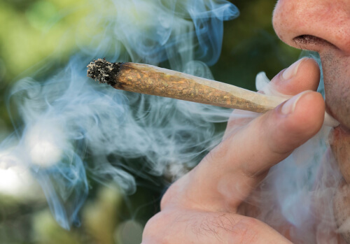 Person smoking joint of marijuana