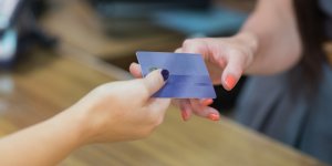 Woman handing over credit card