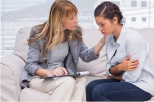 Therapist comforting a patient at office