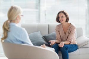 Woman talking to therapist on sofa