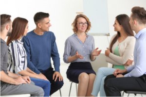 People at group psychotherapy session indoors