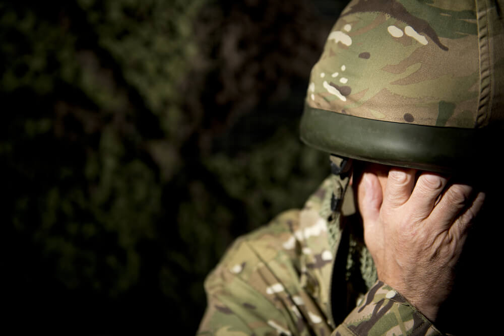 Solider Covering Face With Hands 
