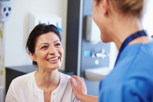 doctor smiling at patient Treating Fear, Anxiety, and Panic as Part of Our COVID-19 Response