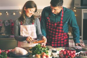 man and woman keeping fit, healthy, and sober this winter by cooking