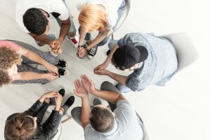 People in addiction treatment in group therapy session